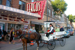Photo of a horse-drawn carriage outside Fergus Theatre in downtown Fergus Falls