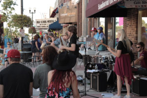 A band playing on the sidewalk in downtown Alexandria, Minnesota